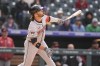 Arizona Diamondbacks' Eugenio Suarez follows the flight of his two-run double off Colorado Rockies pitcher Justin Lawrence in the ninth inning of a baseball game Wednesday, April 10, 2024, in Denver. (AP Photo/David Zalubowski)