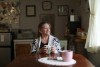 Local resident and postmistress for Canada Post Yvonne Malanfant looks out at the village during coffee in Zeballos, B.C., on Wednesday, April 10, 2024. THE CANADIAN PRESS/Chad Hipolito