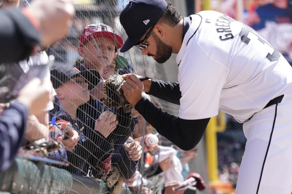Detroit Tigers outfielder Riley Greene signs autographs before the first inning of a baseball game against the Oakland Athletics, Saturday, April 6, 2024, in Detroit. (AP Photo/Carlos Osorio)