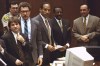 FILE - Defendant O.J. Simpson and members of his defense team react as the jury, many wearing white T-shirts sporting a slogan from a local pizza chain, walk into the courtroom in Los Angeles Friday, May 5, 1995. From left to right are