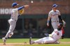 New York Mets shortstop Francisco Lindor (12) makes the play at second base as Atlanta Braves designated hitter Marcell Ozuna (20) is out during the second inning of a baseball game, Thursday, April 11, 2024, in Atlanta. (AP Photo/Mike Stewart)