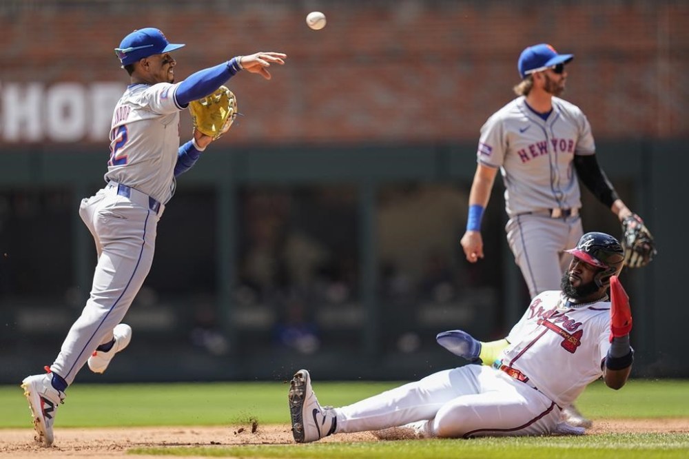 New York Mets shortstop Francisco Lindor (12) makes the play at second base as Atlanta Braves designated hitter Marcell Ozuna (20) is out during the second inning of a baseball game, Thursday, April 11, 2024, in Atlanta. (AP Photo/Mike Stewart)