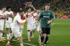 Stuttgart's goalkeeper Alexander Nuebel is celebrated by teammates after winning the German Bundesliga soccer match between Borussia Dortmund and VfB Stuttgart in Dortmund, Germany, Saturday, April 6, 2024. (AP Photo/Martin Meissner)