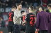 Leverkusen's head coach Xabi Alonso, centre left, celebrates with Leverkusen's Alex Grimaldo after the Europa League quarterfinals first leg soccer match between Bayer 04 Leverkusen and West Ham United at the BayArena in Leverkusen, Germany, Thursday, April 11, 2024. (AP Photo/Martin Meissner)