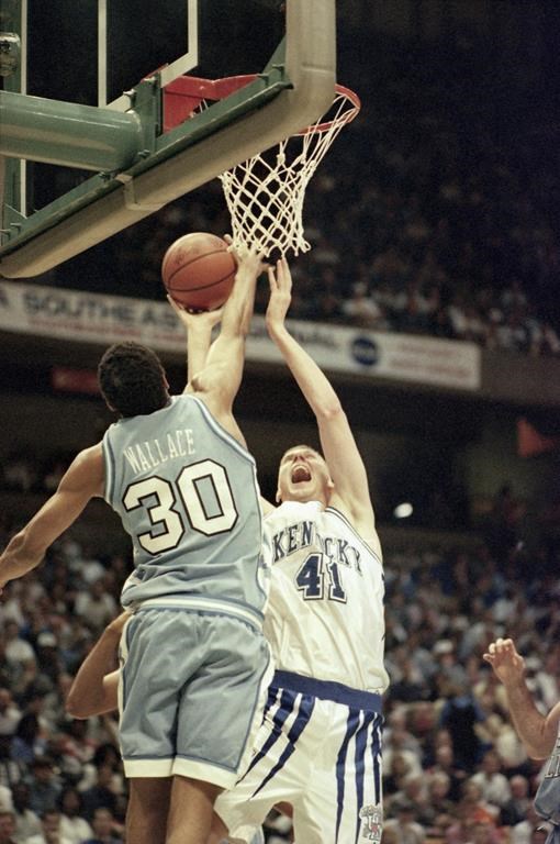 FILE - Kentucky center Mark Pope (41) goes to the basket over North Carolina's Rasheed Wallace (30) during the first half of the NCAA Southeast Regional championship on Saturday, March 25, 1995, at the Birmingham-Jefferson Civic Center in Birmingham, Ala. As a player, Pope led Kentucky with 6.3 rebounds per game during the 1994-95 season and was named to the Southeastern Conference All-Tournament team along with MVP Antoine Walker. Kentucky hired the BYU coach to guide its men’s basketball program, bringing home a captain of the Wildcats’ 1996 national championship team to succeed John Calipari. (AP Photo/Dave Martin, File)
