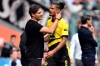 Dortmund coach Edin Terzic, left, talks to Sebastien Haller after being replaced following an injury, during the German Bundesliga soccer match between Borussia Moenchengladbach and Borussia Dortmund at the Borussia Park in Moenchengladbach, Germany, Saturday, April 13, 2024.(Federico Gambarini/dpa via AP)