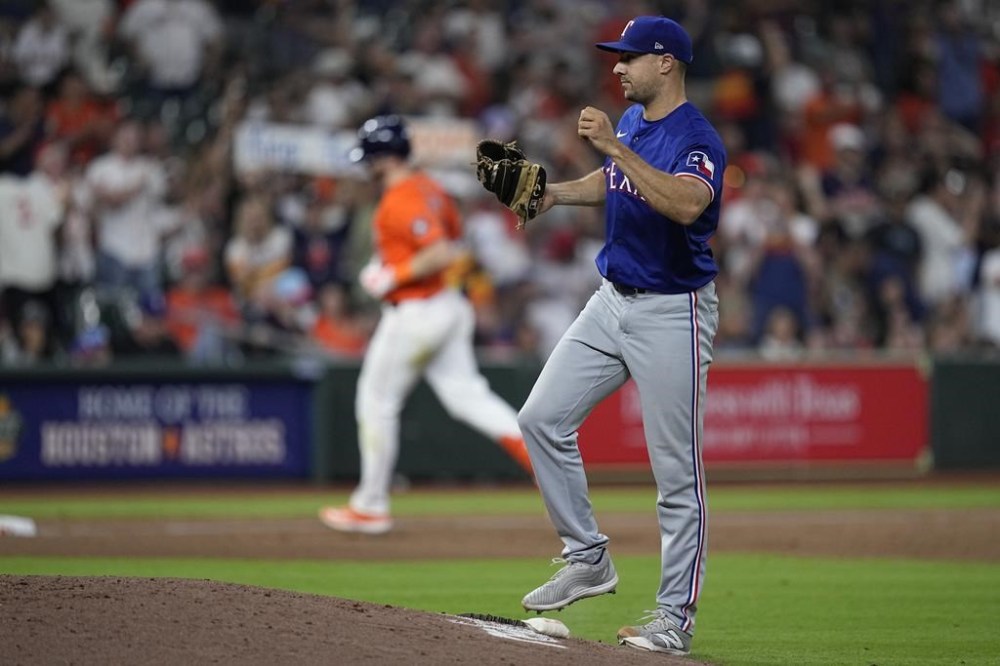 Texas Rangers relief pitcher Brock Burke reacts after giving up a two-run home run to Houston Astros' Kyle Tucker during the seventh inning of a baseball game Friday, April 12, 2024, in Houston. (AP Photo/Kevin M. Cox)