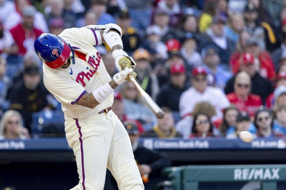 Philadelphia Phillies' Nick Castellanos hits an RBI single during the first inning of a baseball game against the Pittsburgh Pirates, Saturday, April 13, 2024, in Philadelphia. (AP Photo/Laurence Kesterson)