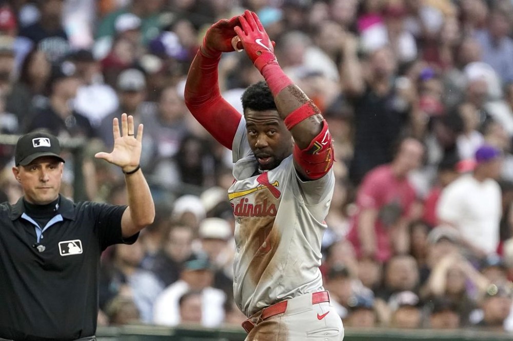 St. Louis Cardinals' Jordan Walker, right, gestures toward his dugout after hitting a triple against Arizona Diamondbacks during the fifth inning of a baseball game Saturday, April 13, 2024, in Phoenix. (AP Photo/Darryl Webb)