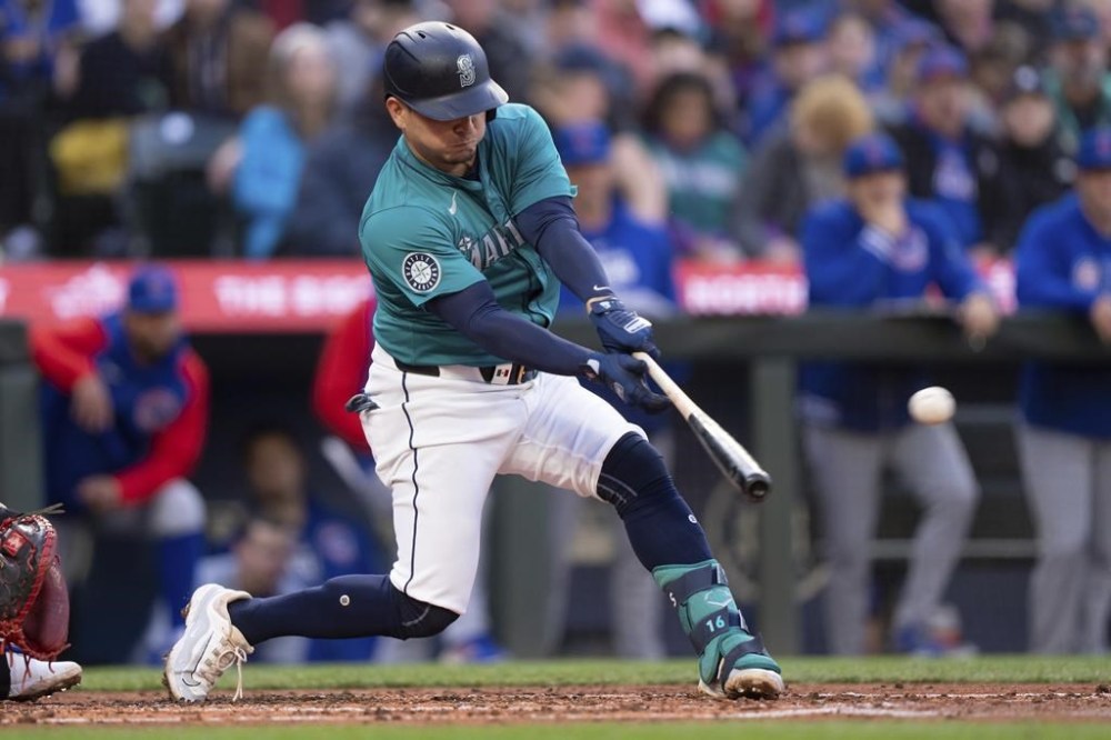 Seattle Mariners' Luis Urias hits an RBI double off Chicago Cubs starting pitcher Shota Imanaga during the second inning of a baseball game, Saturday, April 13, 2024, in Seattle. (AP Photo/Stephen Brashear)