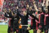 FILE - Leverkusen's head coach Xabi Alonso, centre, celebrates with his team after winning the German Bundesliga soccer match between Bayer Leverkusen and TSG Hoffenheim at the BayArena in Leverkusen, Germany, on March 30, 2024. Excitement was building in Leverkusen, Germany on Sunday ahead of local team Bayer Leverkusen’s expected Bundesliga title win after an outstanding season so far. (AP Photo/Martin Meissner, File)