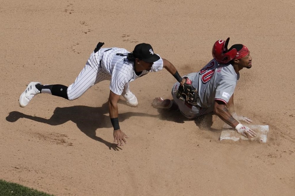 Cincinnati Reds' Will Benson, right, steals second as Chicago White Sox second baseman Nicky Lopez, left, applies a late tag during the sixth inning of a baseball game in Chicago, Sunday, April 14, 2024. (AP Photo/Nam Y. Huh)