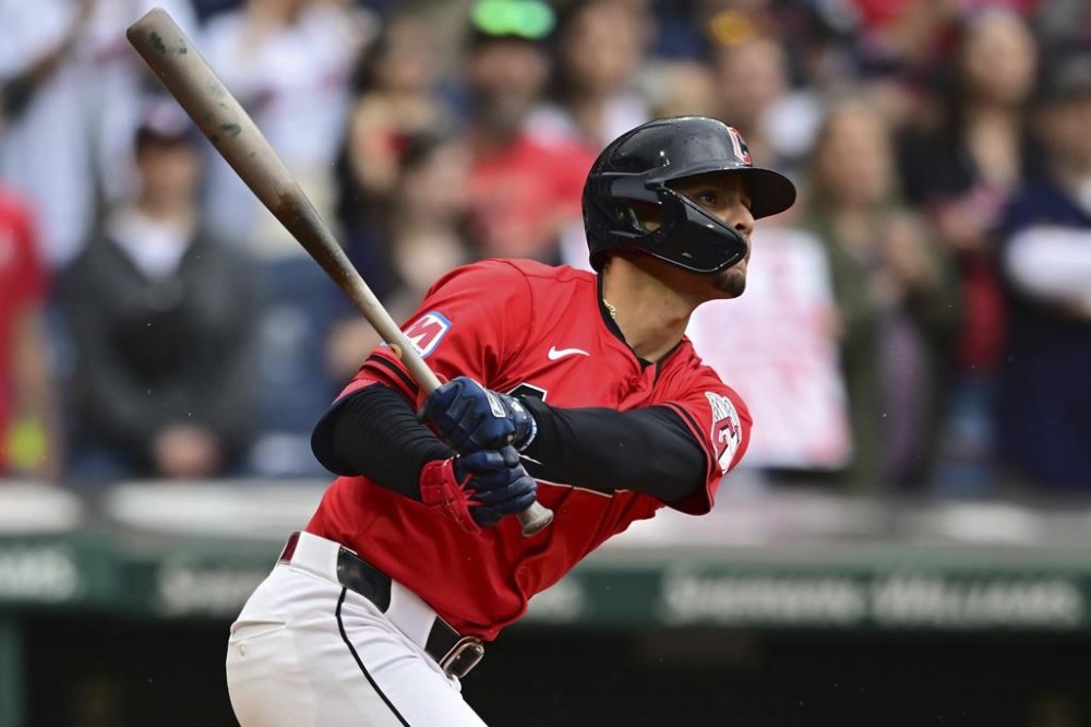 Cleveland Guardians' Andres Gimenez watches his ball after hitting a walkoff sacrifice fly in the 10th inning of a baseball game against the New York Yankees, Sunday, April 14, 2024, in Cleveland. (AP Photo/David Dermer)