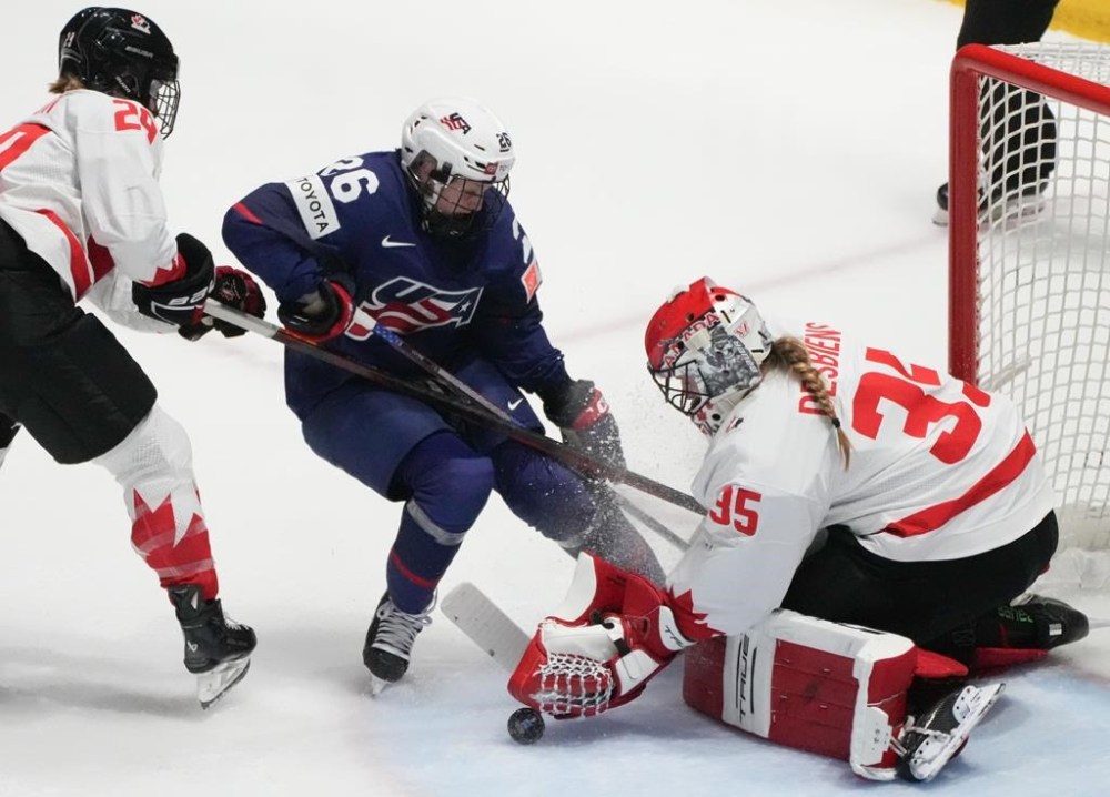 Canada goaltender Ann-Renee Desbiens (35) makes a save against United States' Kendall Coyne Schofield (26) during second period gold medal hockey action at the IIHF Women's World Hockey Championship in Utica, N.Y., Sunday, April 14, 2024. THE CANADIAN PRESS/Christinne Muschi