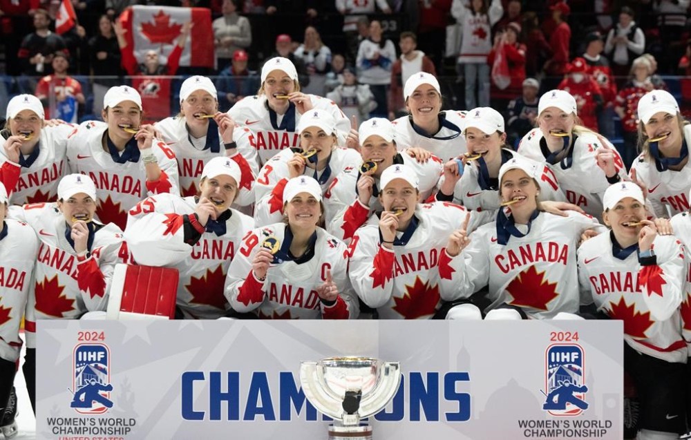Canada players pose with their medals following their gold medal win over United States at the IIHF Women's World Hockey Championship in Utica, N.Y., Sunday, April 14, 2024. THE CANADIAN PRESS/Christinne Muschi