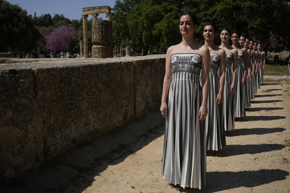 Performers, who will take part in the flame lighting ceremony for the Paris Olympics, join a rehearsal at Ancient Olympia site, Greece, Sunday, April 14, 2024. Every two years, a countdown to the Olympic games is launched from its ancient birthplace with a flame lighting ceremony in southern Greece at Ancient Olympia. The event is marked with a performance by dancers who assume the role of priestesses and male companions, their movement inspired by scenes on millennia-old artwork. (AP Photo/Thanassis Stavrakis)
