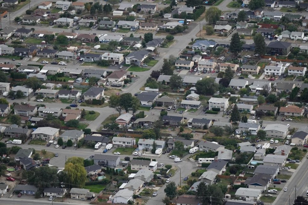 Home sales in British Columbia fell by almost 10 per cent in March compared with the same period last year, in a slowdown an analyst says could be buyers waiting for lower interest rates. Houses are seen in an aerial view in a residential neighbourhood, in Kamloops, B.C., Monday, Sept. 11, 2023. THE CANADIAN PRESS/Darryl Dyck