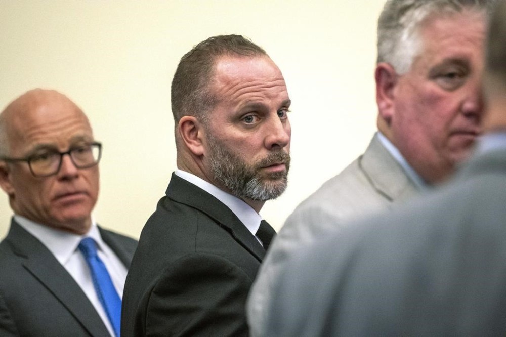 FILE - Former Franklin County Sheriff's office deputy Jason Meade, center, stands with two of his defense attorneys Steve Nolder, left, and Mark Collins, Jan. 31, 2024 in Columbus, Ohio. The retrial of the former Ohio sheriff’s deputy charged with murder in the killing of a Black man will be held this fall. The Oct. 31 trial date for Meade was confirmed during a status conference held Monday, April 15, 2024 by Franklin County Common Pleas Court Judge David Young. (Brooke LaValley/The Columbus Dispatch via AP, File)