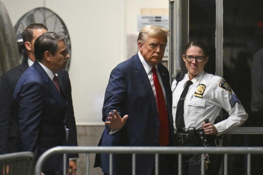 Former President Donald Trump gives a thumbs up as he returns to the courtroom after a break during the first day of his trial at Manhattan Criminal Court in New York, on Monday, April 15, 2024. Trump's hush money trial begins Monday with jury selection. It's a singular moment for American history as the first criminal trial of a former U.S. commander in chief. (Angela Weiss/Pool Photo via AP)