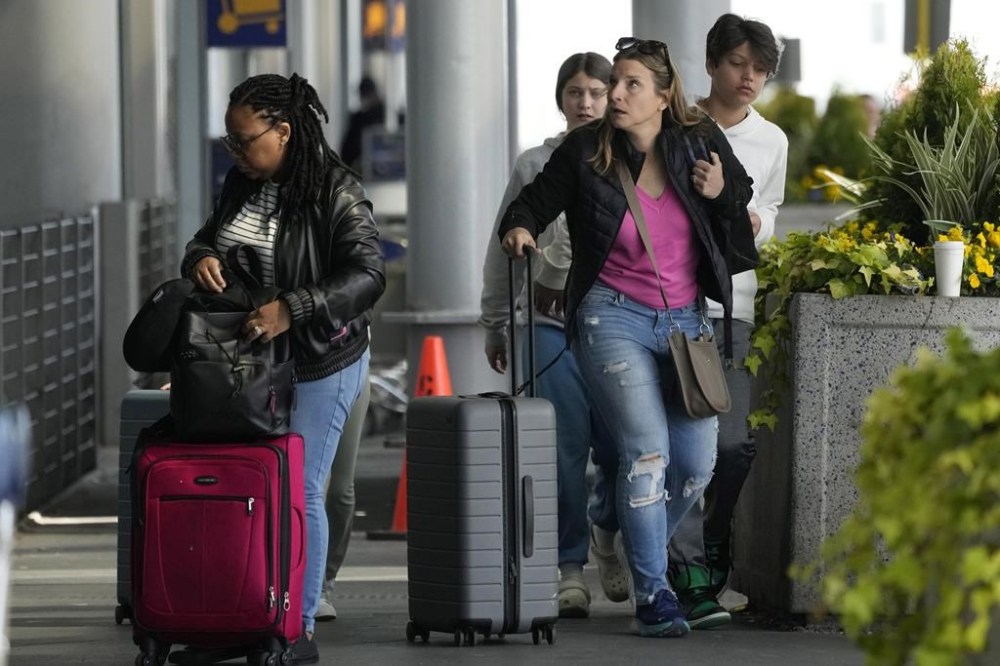 TravelLers walk to Terminal 1 at O'Hare International Airport in Chicago, Monday, April 15, 2024. Pro-Palestinian demonstrators blocked a freeway leading to three Chicago O'Hare International Airport terminals Monday morning, temporarily stopping vehicle traffic into one of the nation's busiest airports and causing headaches for travelLers. (AP Photo/Nam Y. Huh)