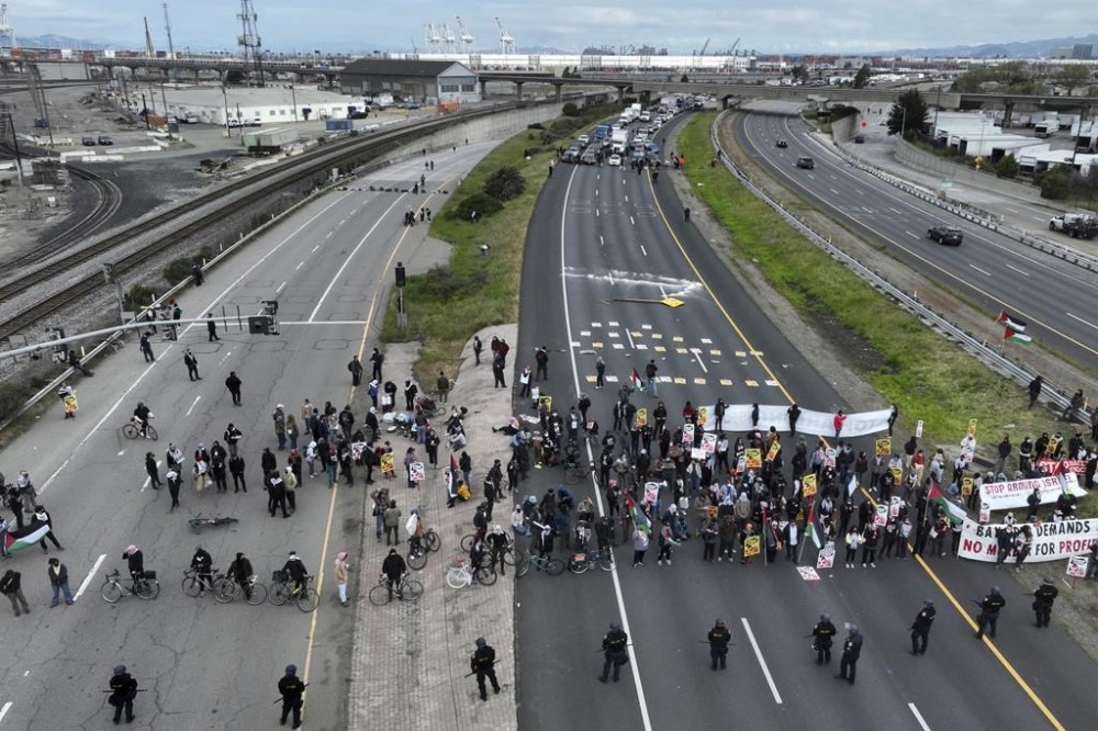 Protesters calling for a cease fire in Gaza shut down southbound traffic on Highway 880 in Oakland, Calif. on Monday, April 15, 2024. (Bronte Wittpenn/San Francisco Chronicle via AP)