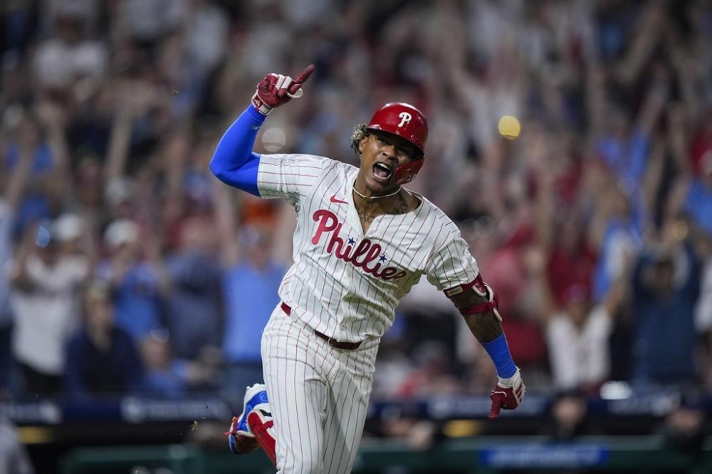 Philadelphia Phillies' Cristian Pache reacts after hitting a RBI single off Colorado Rockies pitcher Jacob Bird during the 10th inning of a baseball game, Monday, April 15, 2024, in Philadelphia. (AP Photo/Matt Rourke)