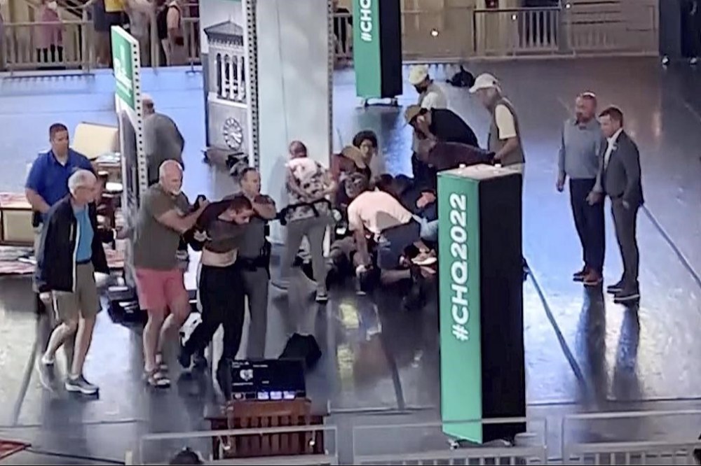 FILE - This still image from video shows Hadi Matar, of Fairview, N.J., at left, being escorted from the stage as people tend to author Salman Rushdie, center right, at the Chautauqua Institution, in Chautauqua, N.Y., Aug. 12, 2022. Rushdie's first book since the 2022 stabbing he thought might end his life is both explicit in the violence Rushdie sustains and heroic in the will to live that Rushdie retains. (AP Photo/File)
