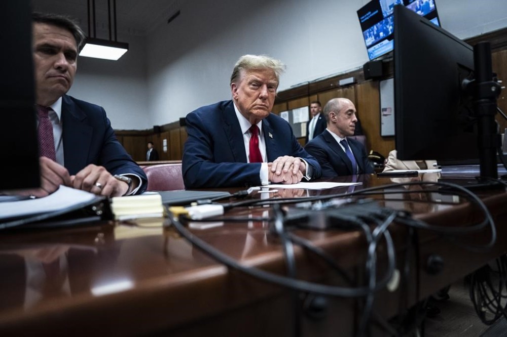 FILE - Former President Donald Trump sits in Manhattan criminal court with his legal team in New York, April 15, 2024. A new AP-NORC Center for Public Affairs Research poll found that only about one-third of U.S. adults think Trump did something illegal in the hush money case for which jury selection began Monday, while close to half think he did something illegal in the other three criminal cases pending against him. Still, about half of Americans would consider Trump unfit to serve as president if he is convicted. (Jabin Botsford/Pool Photo via AP)