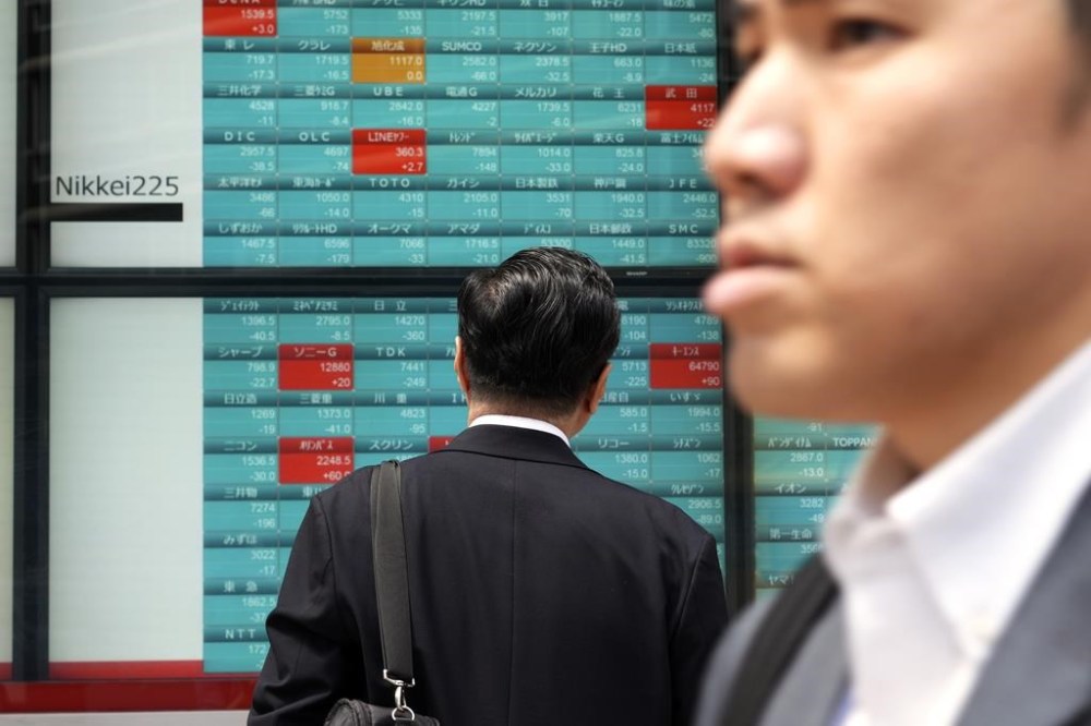 A person looks at an electronic stock board showing Japan's Nikkei 225 index at a securities firm Tuesday, April 16, 2024, in Tokyo. (AP Photo/Eugene Hoshiko)