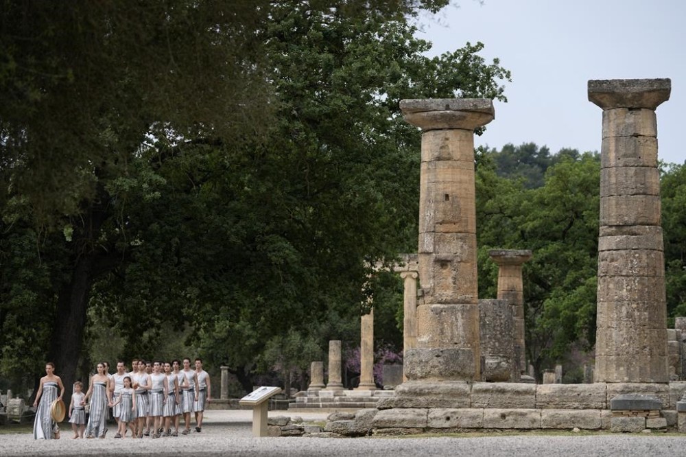 Performers take part in the official ceremony of the flame lighting for the Paris Olympics, at the Ancient Olympia site, Greece, Tuesday, April 16, 2024. The flame will be carried through Greece for 11 days before being handed over to Paris organizers on April 26. (AP Photo/Thanassis Stavrakis)