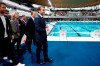 French President Emmanuel Macron, surrounded by Tony Estanguet, president of the Paris 2024 Olympics Organising Committee, left, Ile-de-France's Regional Council President Valerie Pecresse, third left, and Grand Paris' Metropole President Patrick Ollier visit the Olympic Aquatics Center (CAO), a multifunctional venue for the 2024 Paris Olympic in Saint-Denis, near Paris, Thursday, April 4, 2024. The aquatic center will host the artistic swimming, water polo and diving events during the Paris 2024 Olympic Games. (Gonzalo Fuentes/Pool via AP)