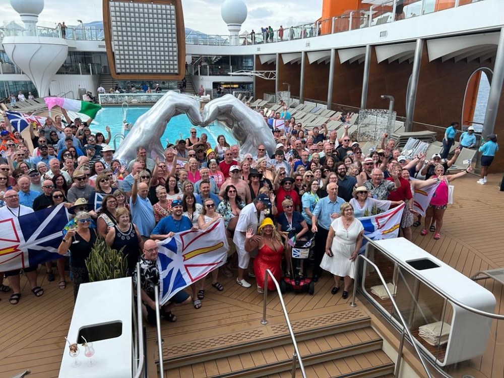 About 500 Newfoundlanders were inadvertently booked on the same 3,000-person Caribbean cruise this month. Pictured in this handout photo taken April 12, 2024, near Cuba, they had a Newfoundland party on the main pool deck. THE CANADIAN PRESS/HO