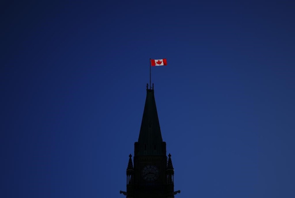 The Canada flag catches the morning light on the Peace Tower on Parliament Hill in Ottawa on Tuesday, April 16, 2024. THE CANADIAN PRESS/Sean Kilpatrick