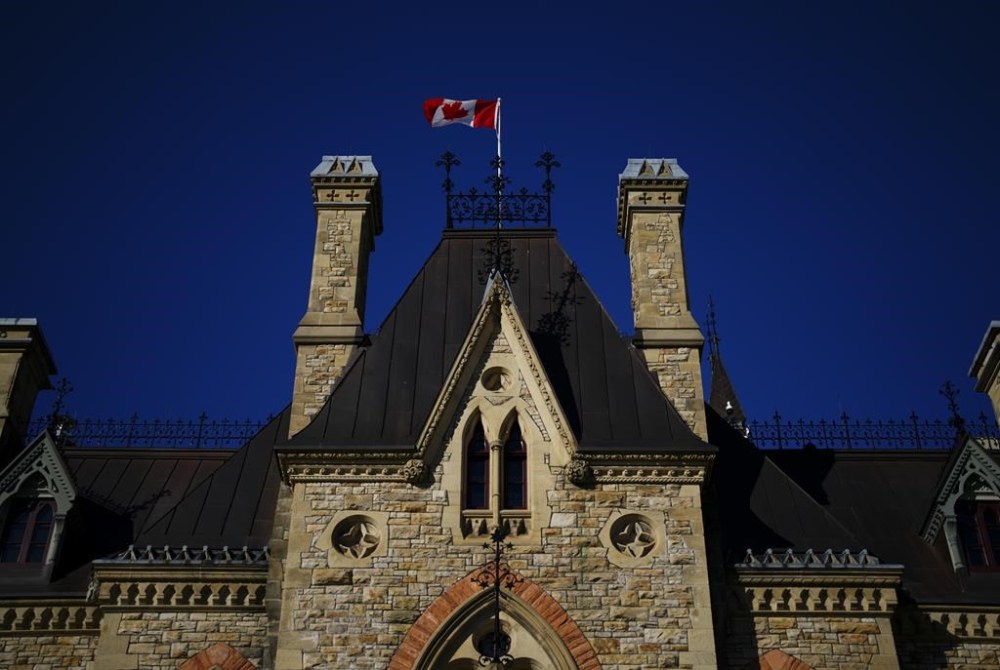 A Canada flag flies on top of the West Block on Parliament Hill in Ottawa on Tuesday, April 16, 2024. THE CANADIAN PRESS/Sean Kilpatrick