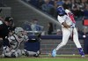 Toronto Blue Jays' Vladimir Guerrero Jr. (27) hits a two RBI single as New York Yankees catcher Jose Trevino (39) looks on during fourth inning American League MLB baseball action in Toronto on Tuesday, April 16, 2024. THE CANADIAN PRESS/Nathan Denette