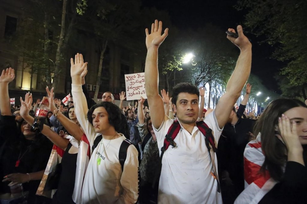 Demonstrators react listening to a speaker as they gather outside the parliament building in Tbilisi, Georgia, on Wednesday, April 17, 2024, to protest against