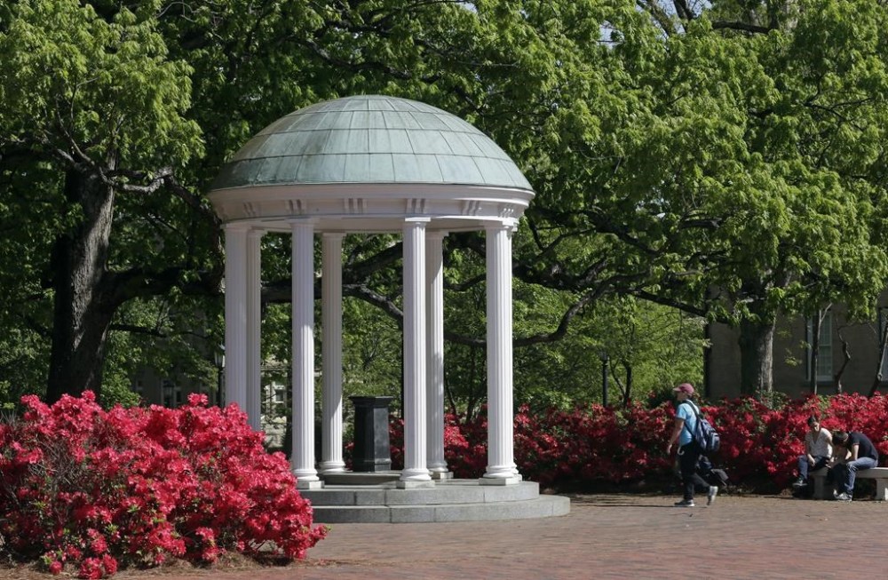 FILE - The Old Well on the University of North Carolina at Chapel Hill is seen among the spring foliage, April 20, 2015, in Chapel Hill, N.C. The future of diversity, equity and inclusion staff jobs in North Carolina's public university system could be at stake as a series of votes loom on a key policy's potential repeal. The Committee on University Governance within the University of North Carolina Board of Governors that oversees 17 schools, was poised to vote Wednesday, April 17, 2024, on a possible reversal and replacement of a policy related to DEI. (AP Photo/Gerry Broome, File)