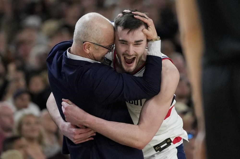 UConn head coach Dan Hurley celebrates with forward Alex Karaban (11) after their win against Purdue in the NCAA college Final Four championship basketball game, Monday, April 8, 2024, in Glendale, Ariz. (AP Photo/David J. Phillip)