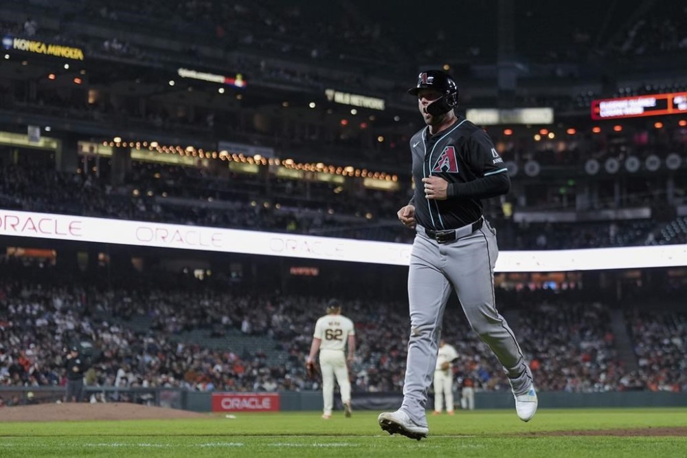 Arizona Diamondbacks' Christian Walker jogs to the dugout after being caught off first during the seventh inning of the team's baseball game against the San Francisco Giants, Thursday, April 18, 2024, in San Francisco. (AP Photo/Godofredo A. Vásquez)