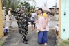A woman carries a baby in a sling on her back as she shows her papers to a security personnel at a polling booth before casting her vote during the first round of polling of India's national election in Bishnupur constituency on the outskirts of Imphal, Manipur, India, Friday, April 19, 2024. Nearly 970 million voters will elect 543 members for the lower house of Parliament for five years, during staggered elections that will run until June 1. (AP Photo/Bullu Raj)