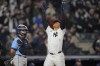 New York Yankees' Juan Soto, right, celebrates as he reaches home plate after hitting a three-run home run during the seventh inning of a baseball game as Tampa Bay Rays catcher Ben Rortvedt watches Friday, April 19, 2024, in New York. (AP Photo/Frank Franklin II)