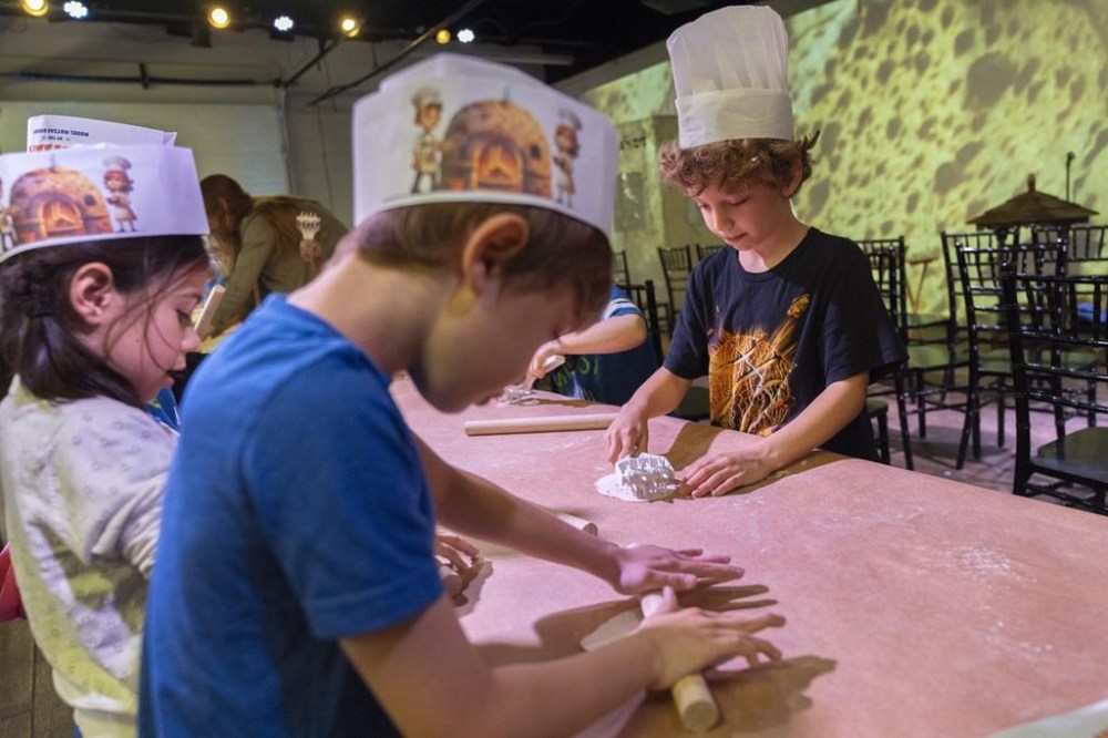 First graders from Milton Gottesman Jewish Day School of the Nation's Capital, make matzah during a