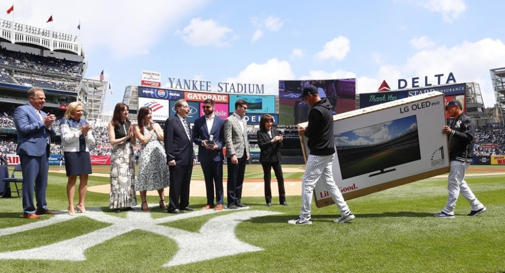 New York Yankees broadcaster John Sterling is presented with a television during retirement ceremony before a baseball game against the Tampa Bay Rays at Yankee Stadium in New York, Saturday, April 20, 2024 (AP Photo/Noah K. Murray)