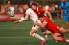 Team USA's Steve Tomasin passes the ball off as Team Canada's Elias Ergas during the men's gold medal match at the Rugby Sevens Paris 2024 Olympic qualification event at Starlight Stadium in Langford, B.C., on Sunday, August 20, 2023. THE CANADIAN PRESS/Chad Hipolito
