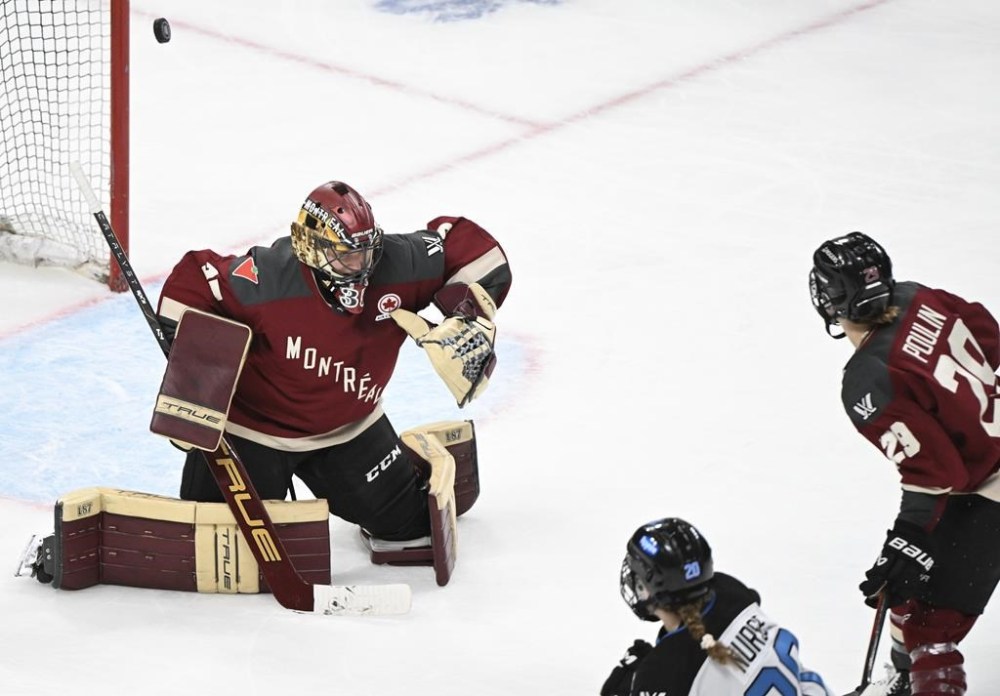 Toronto's Sarah Nurse (20) scores against Montreal goaltender Ann-RenEe Desbiens as Montreal's Marie-Philip Poulin (29) looks on during overtime period PWHL hockey action at the Bell Centre in Montreal, Saturday, April 20, 2024. THE CANADIAN PRESS/Graham Hughes