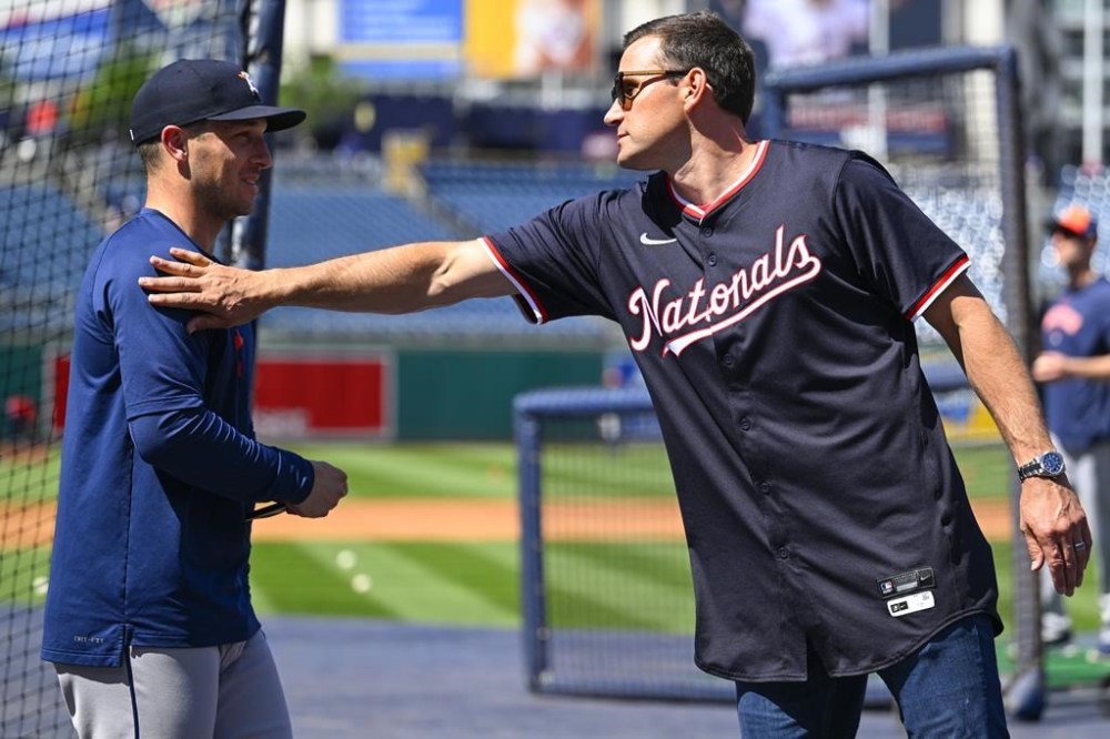 Houston Astros Alex Bregman, left, is greeted by former Washington Nationals player Ryan Zimmerman during the Astros batting practice, Saturday, April 20, 2024 in Washington. Zimmerman was part of a five year anniversary celebrating the Nationals win over Bergman and the Astros in the 2019 World Series. The ceremonies were held before a baseball game between the two teams at Nationals Park in Washington. (AP Photo/John McDonnell)