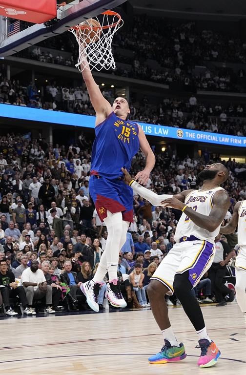 Denver Nuggets center Nikola Jokic (15) goes up to shoot against Los Angeles Lakers forward LeBron James, right, during the second half in Game 1 of an NBA basketball first-round playoff series Saturday, April 20, 2024, in Denver. (AP Photo/Jack Dempsey)