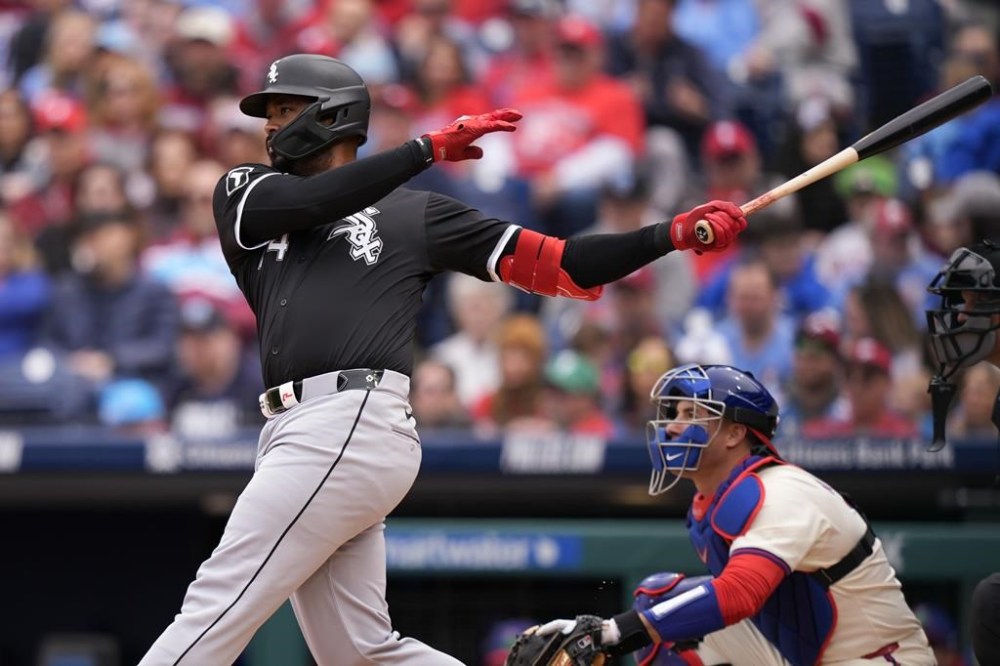 Chicago White Sox's Eloy Jimenez follows through after hitting a two-run home run against Philadelphia Phillies pitcher Aaron Nola during the first inning of a baseball game, Sunday, April 21, 2024, in Philadelphia. (AP Photo/Matt Slocum)