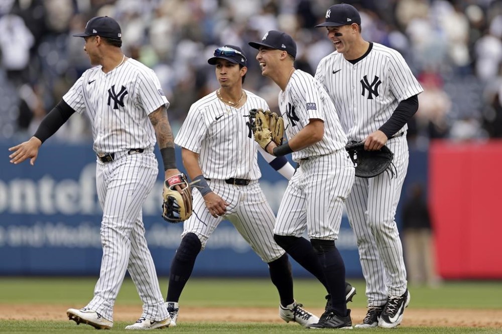 From left to right, New York Yankees' Gleyber Torres, Oswaldo Cabrera, Anthony Volpe and Anthony Rizzo celebrate after defeating the Tampa Bay Rays in a baseball game Sunday, April 21, 2024, in New York. (AP Photo/Adam Hunger)