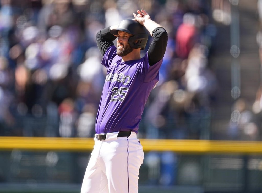 Colorado Rockies' Jacob Stallings reacts after he was called out due to fan interference on a possible winning solo home run in the ninth inning of the first game of a baseball doubleheader against the Seattle Mariners, Sunday, April 21, 2024, in Denver. (AP Photo/David Zalubowski)